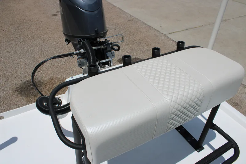 Slide: The Image of 2027 Freedom Boats Chiquita with cushioned seating and motor, showcasing modern design. - 7
