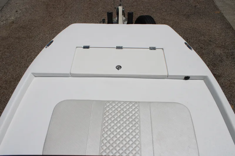Slide: The Image of 2027 Freedom Boats Chiquita deck with storage compartment and cushioned seating. - 11