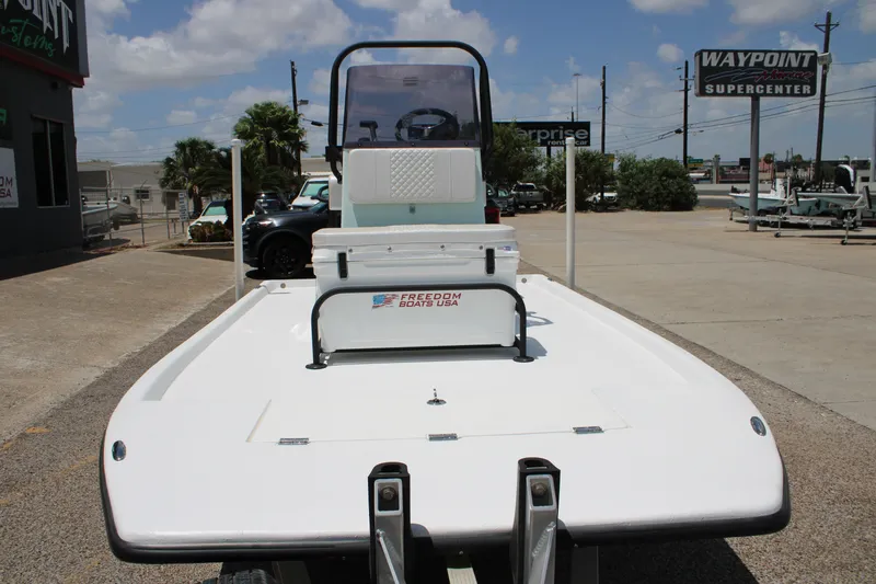 Slide: The Image of 2027 Freedom Boats Chiquita on trailer at Waypoint Supercenter under sunny skies. - 5