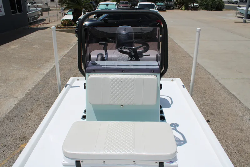Slide: The Image of 2027 Freedom Boats Chiquita interior with white seating and steering console. - 6