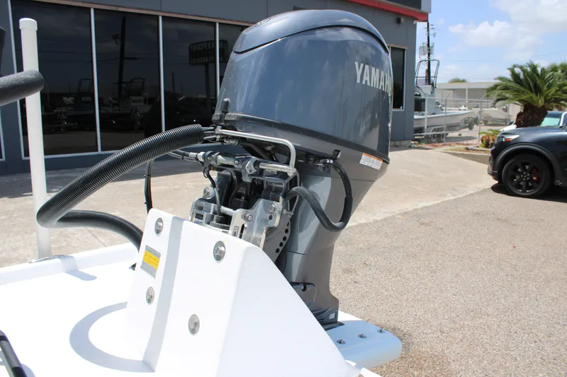 Slide: The Image of Outboard motor on a 2027 Freedom Boats Chiquita, parked outdoors. - 16