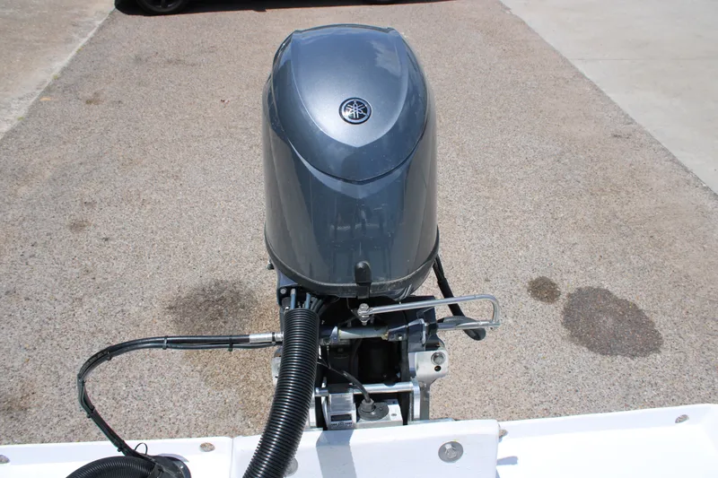 Slide: The Image of 2027 Freedom Boats Chiquita outboard motor on pavement background. - 10