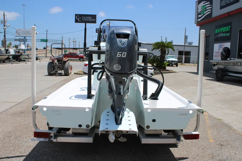 Slide: The Image of 2027 Freedom Boats Chiquita with Yamaha 60 engine at a dealership. - 4