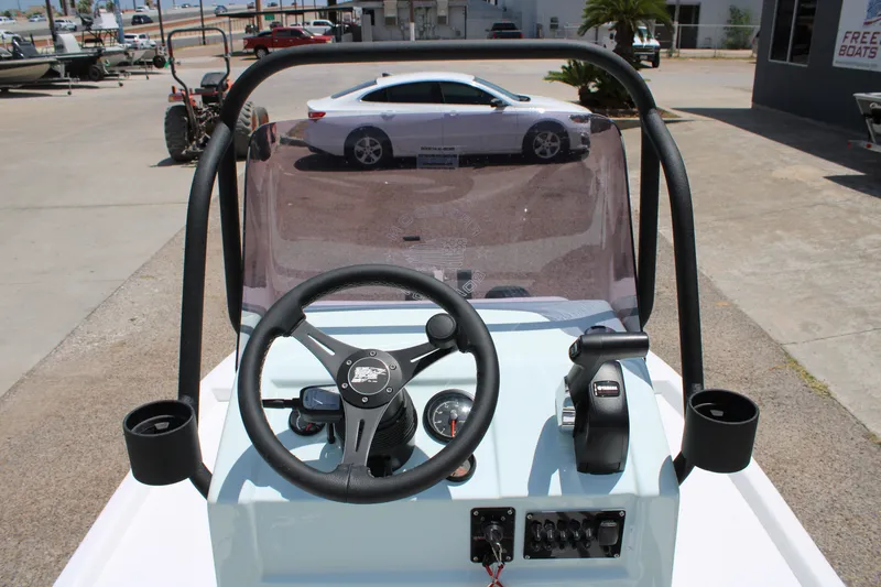 Slide: The Image of Steering console of 2027 Freedom Boats Chiquita with clear windshield and controls. - 8