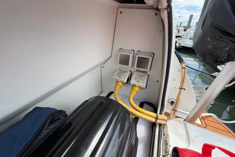 Slide: The Image of 2008 Bayliner 300 boat with shore power connections at a marina. - 18