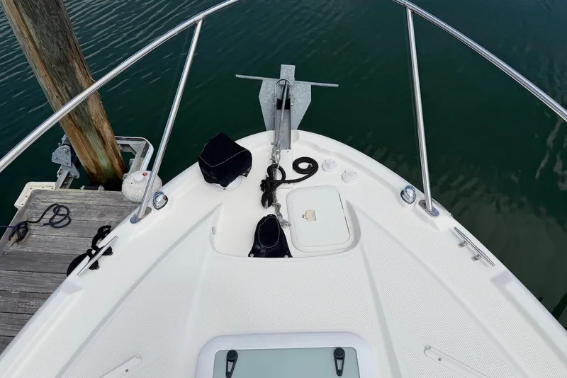 Slide: The Image of Bow of a 2008 Bayliner 300 boat docked at a marina. - 3