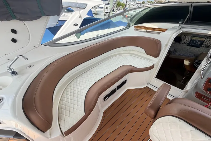 Slide: The Image of Luxurious 2008 Bayliner 300 boat interior with brown and white seating, wood accents. - 11