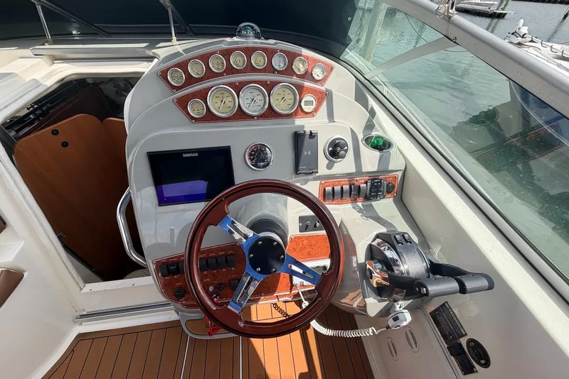 Slide: The Image of 2008 Bayliner 300 boat dashboard with gauges, steering wheel, and control panel. - 10