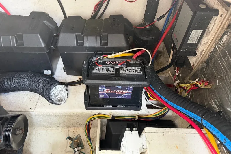 Slide: The Image of Battery compartment of a 2008 Bayliner 300 boat with wiring and components. - 22