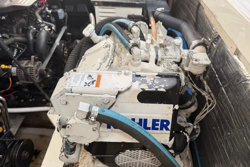 Slide: The Image of Engine compartment of a 2008 Bayliner 300 boat, featuring mechanical components and hoses. - 24