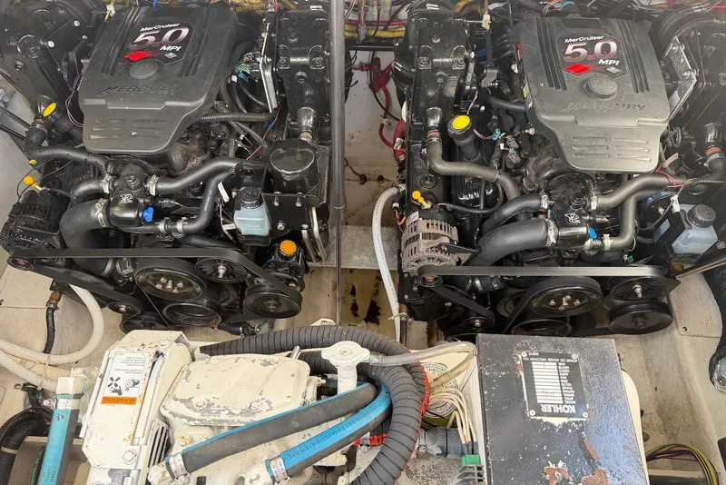Slide: The Image of Twin MerCruiser engines in a 2008 Bayliner 300 boat, showcasing engine details and components. - 21