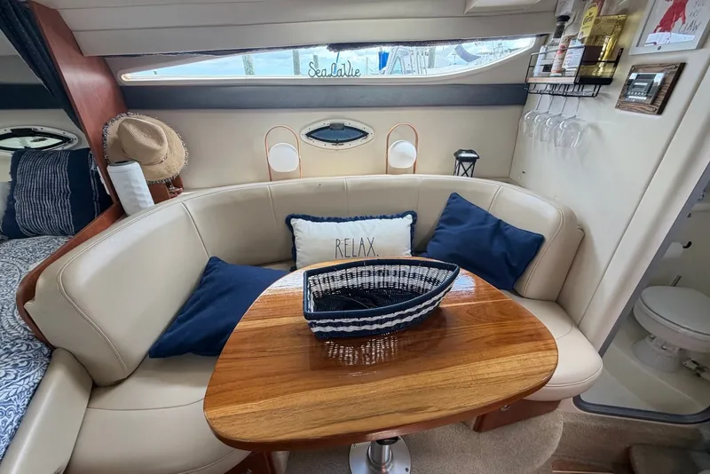 Slide: The Image of Interior of 2008 Bayliner 300 yacht with cozy seating and nautical decor. - 13