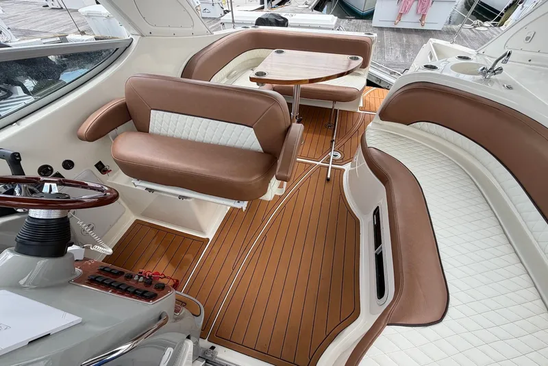 Slide: The Image of Luxurious interior of a 2008 Bayliner 300 boat with brown and white seating. - 5