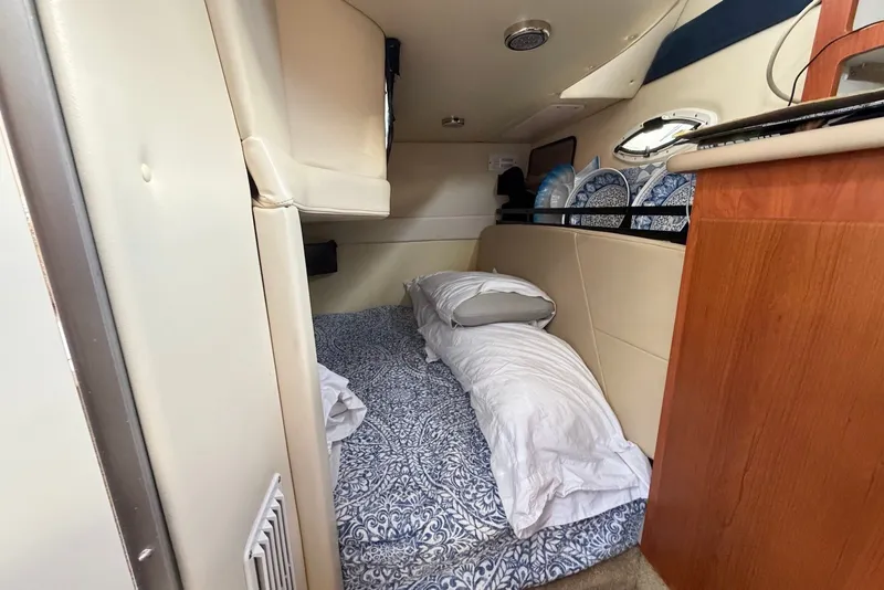 Slide: The Image of Interior cabin of a 2008 Bayliner 300 boat with cozy bedding setup. - 16
