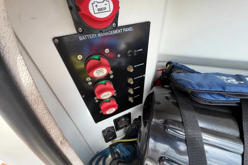 Slide: The Image of Battery management panel on 2008 Bayliner 300 boat, featuring switches and storage bag. - 19