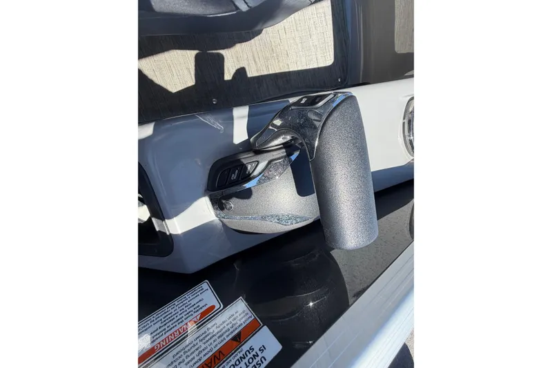 Slide: The Image of Throttle control of 2022 Bennington 25 QX boat, featuring sleek design and ergonomic handle. - 27