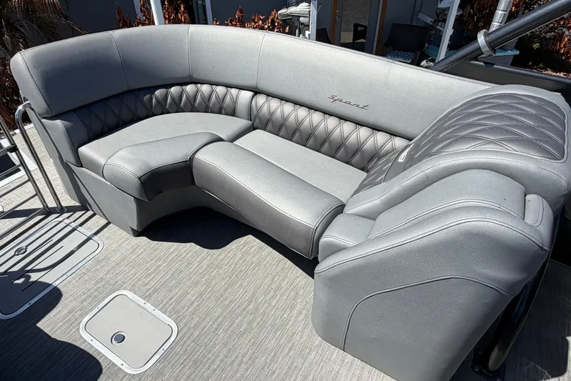 Slide: The Image of Luxurious seating on a 2022 Bennington 25 QX boat, featuring elegant gray upholstery. - 22