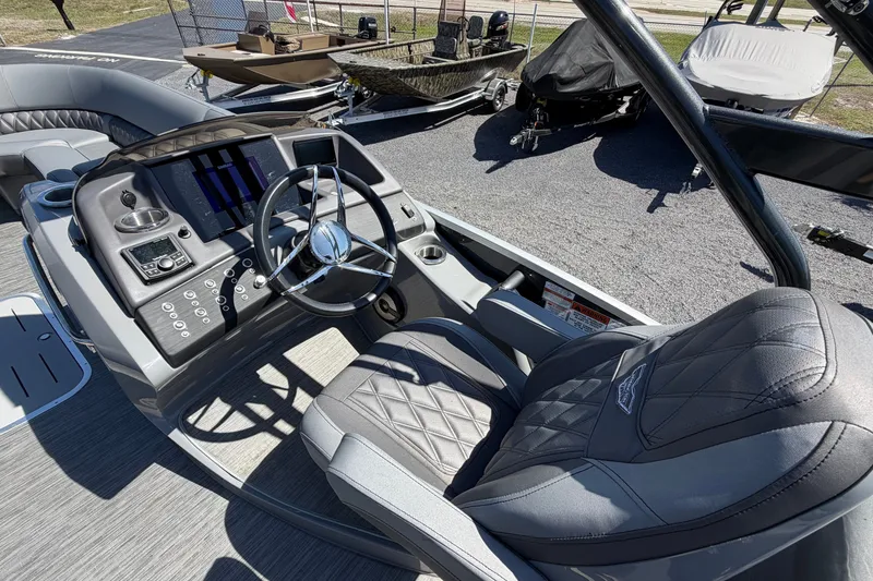 Slide: The Image of 2022 Bennington 25 QX boat interior with steering wheel and control panel. - 20