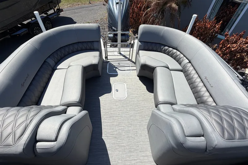 Slide: The Image of 2022 Bennington 25 QX boat interior with luxurious gray seating and spacious layout. - 14