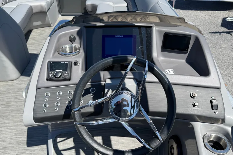 Slide: The Image of Steering console of 2022 Bennington 25 QX boat with modern controls and displays. - 21