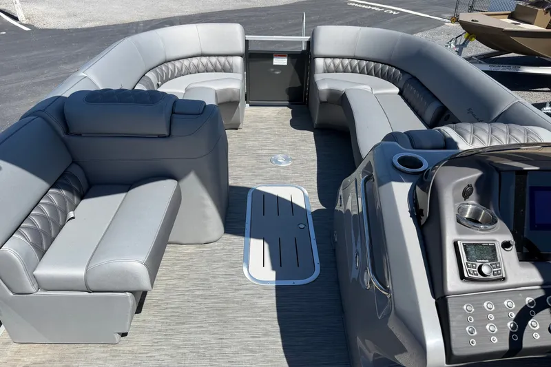 Slide: The Image of 2022 Bennington 25 QX pontoon boat interior with luxurious gray seating and modern dashboard. - 15