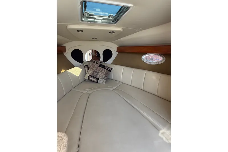 Slide: The Image of Interior cabin of 2009 Rinker 260 Express Cruiser with cushions and porthole. - 15