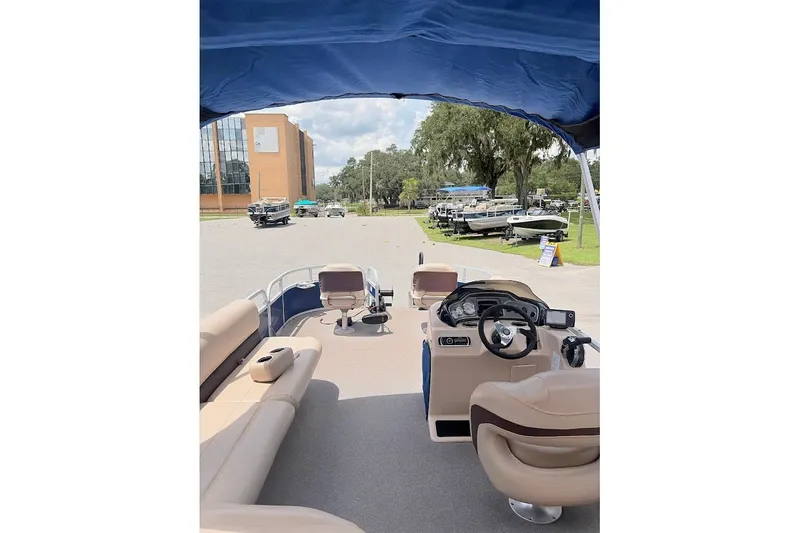 Slide: The Image of 2017 Sun Tracker Fishin' Barge 20 DLX interior view with seating and steering console. - 15