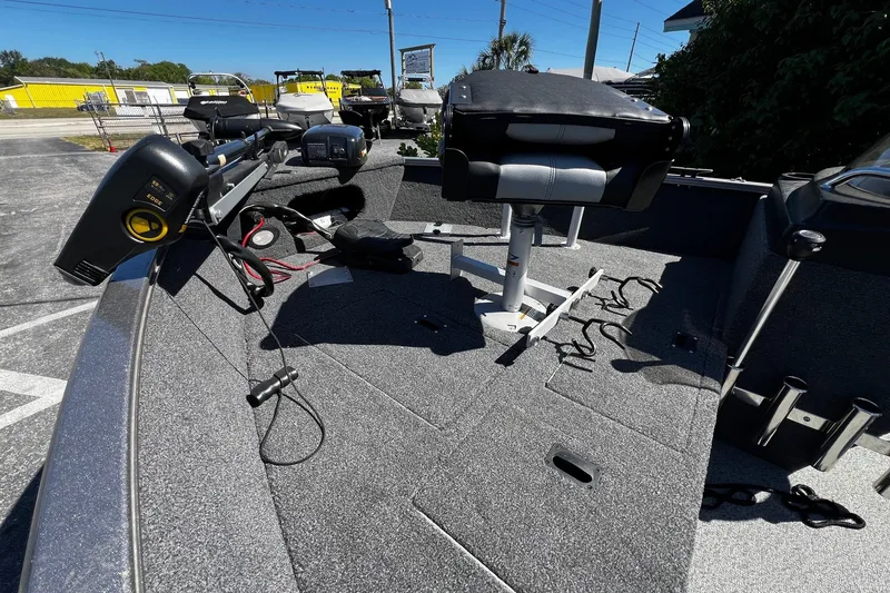Slide: The Image of 2023 Crestliner 1600 Vision boat interior with seating and equipment, parked outdoors. - 10