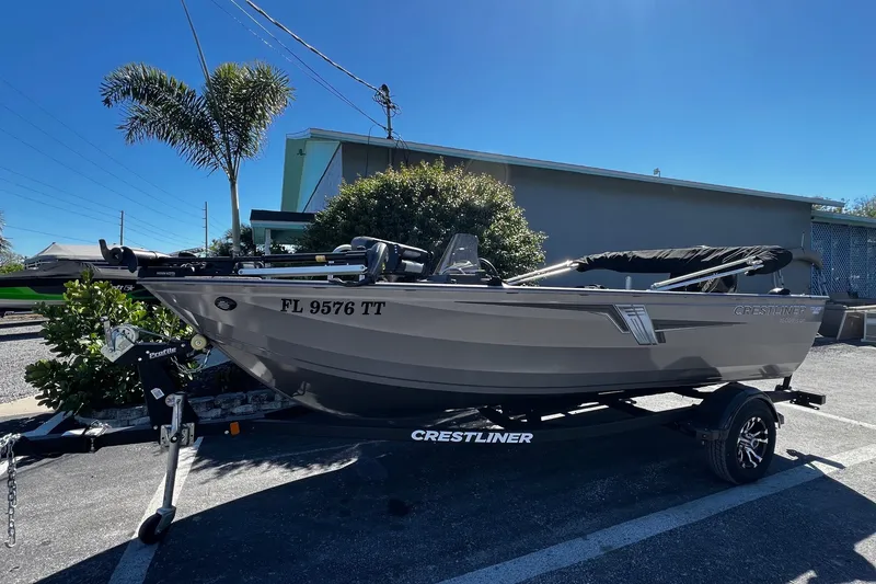 The Image of 2023 Crestliner 1600 Vision boat on trailer, parked outdoors under clear sky. - 1