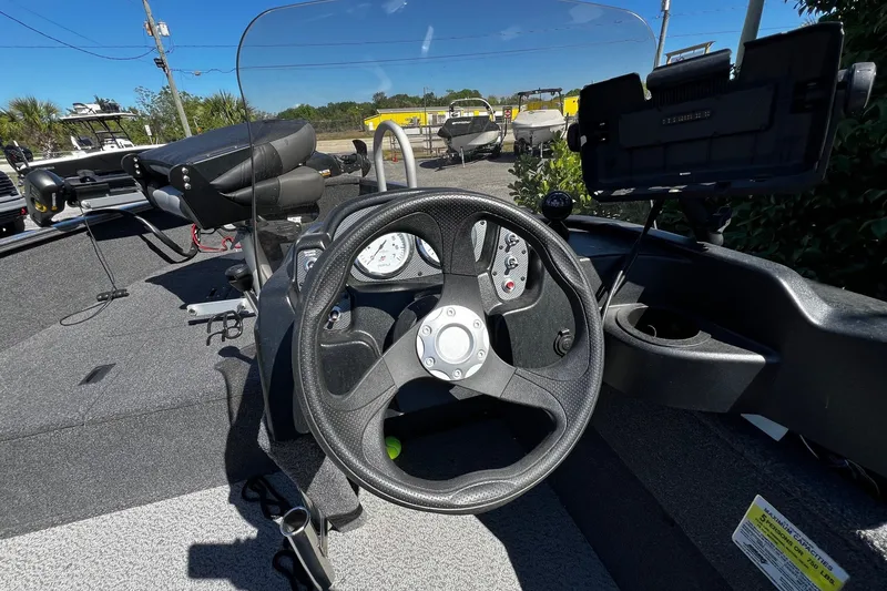 Slide: The Image of 2023 Crestliner 1600 Vision boat dashboard with steering wheel and controls. - 9