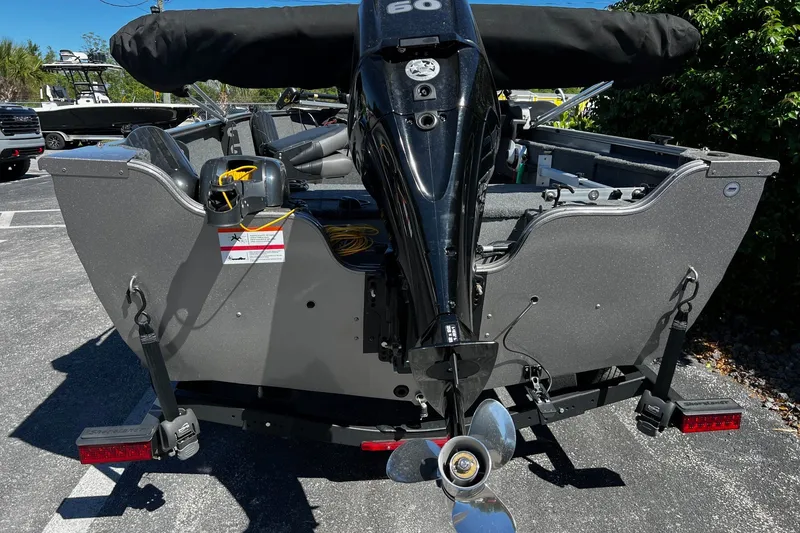 Slide: The Image of 2023 Crestliner 1600 Vision boat with outboard motor, parked on a trailer. - 6