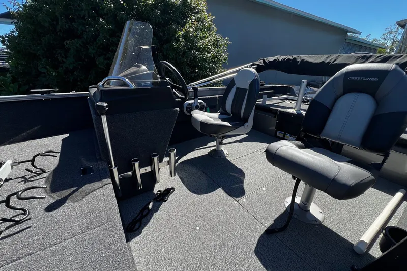 Slide: The Image of 2023 Crestliner 1600 Vision boat interior with steering console and seating. - 11