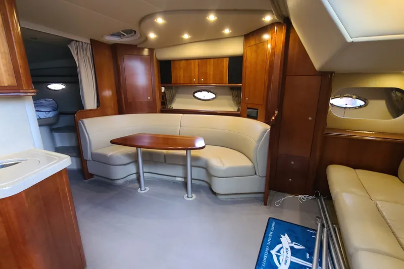 Slide: The Image of Luxurious interior of 2006 Cruisers Yachts 370 Express with elegant wood finishes and plush seating. - 18