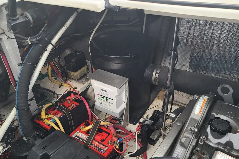 Slide: The Image of Engine compartment of a 2006 Cruisers Yachts 370 Express with batteries and wiring. - 35