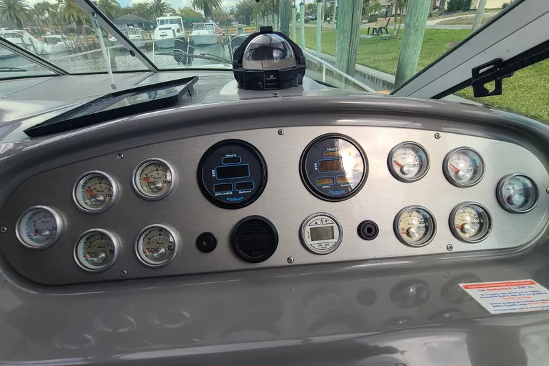 Slide: The Image of Dashboard of a 2006 Cruisers Yachts 370 Express with gauges and controls. - 13