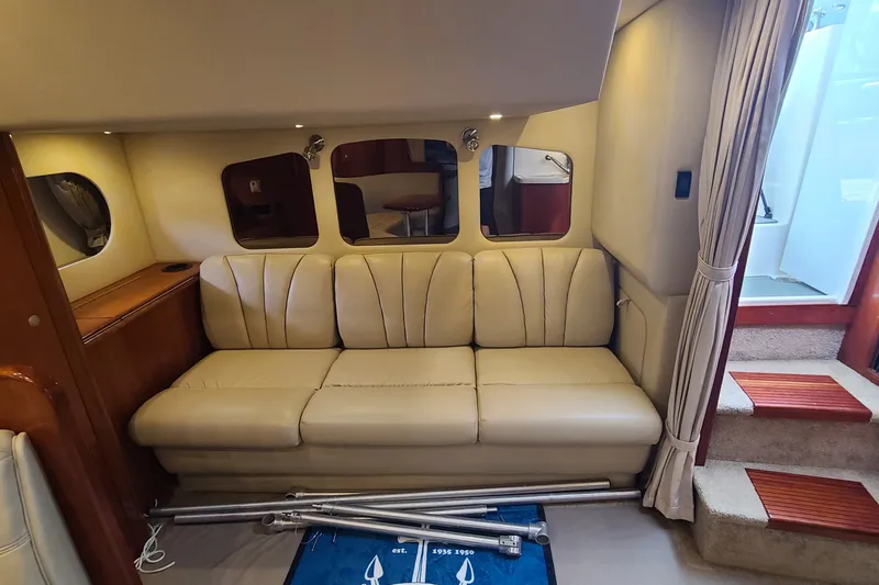 Slide: The Image of 2006 Cruisers Yachts 370 Express interior with beige leather seating and wooden accents. - 20
