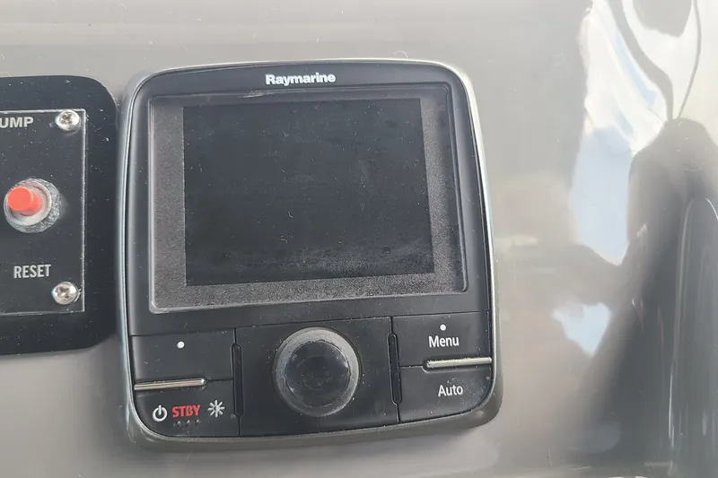 Slide: The Image of Raymarine display on 2006 Cruisers Yachts 370 Express dashboard, featuring control buttons. - 15