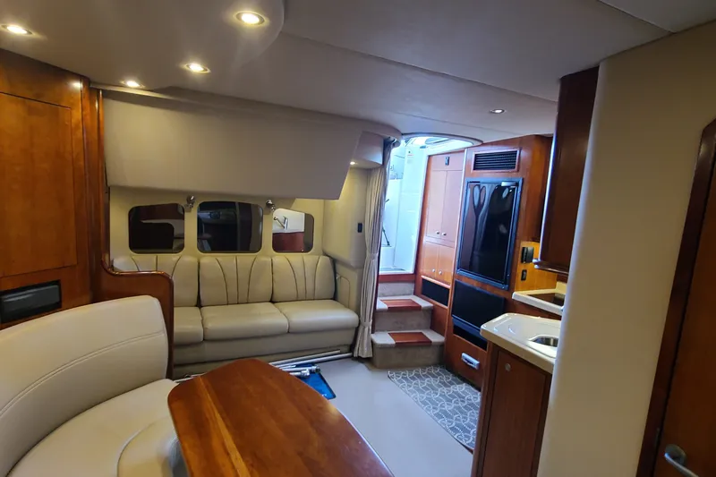 Slide: The Image of Interior of 2006 Cruisers Yachts 370 Express, featuring elegant seating and modern amenities. - 24