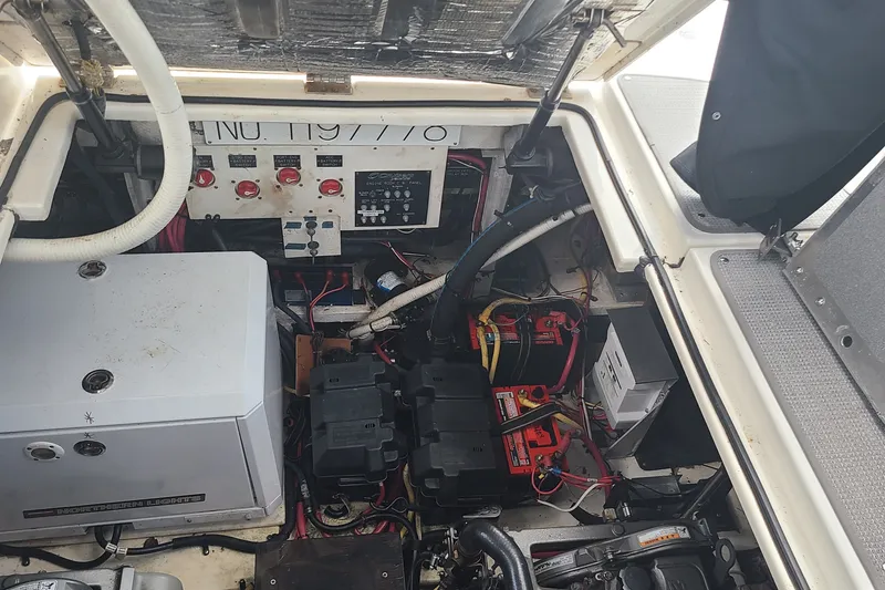 Slide: The Image of Engine compartment of a 2006 Cruisers Yachts 370 Express, showcasing electrical components and wiring. - 34