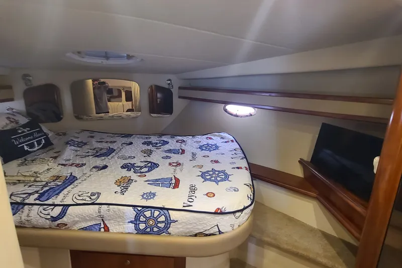 Slide: The Image of Cozy cabin interior of 2006 Cruisers Yachts 370 Express with nautical-themed bedding. - 22