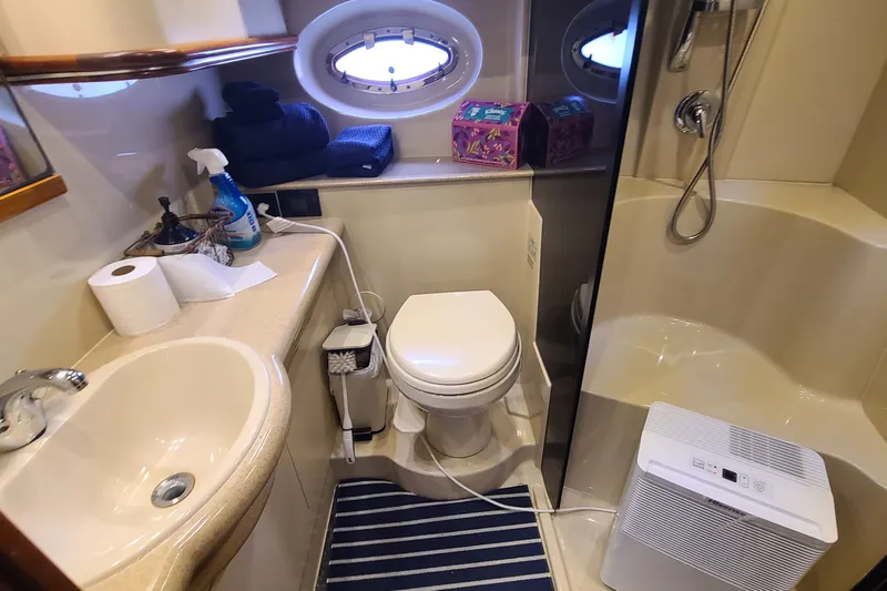 Slide: The Image of Bathroom interior of 2006 Cruisers Yachts 370 Express with sink, toilet, and shower. - 27