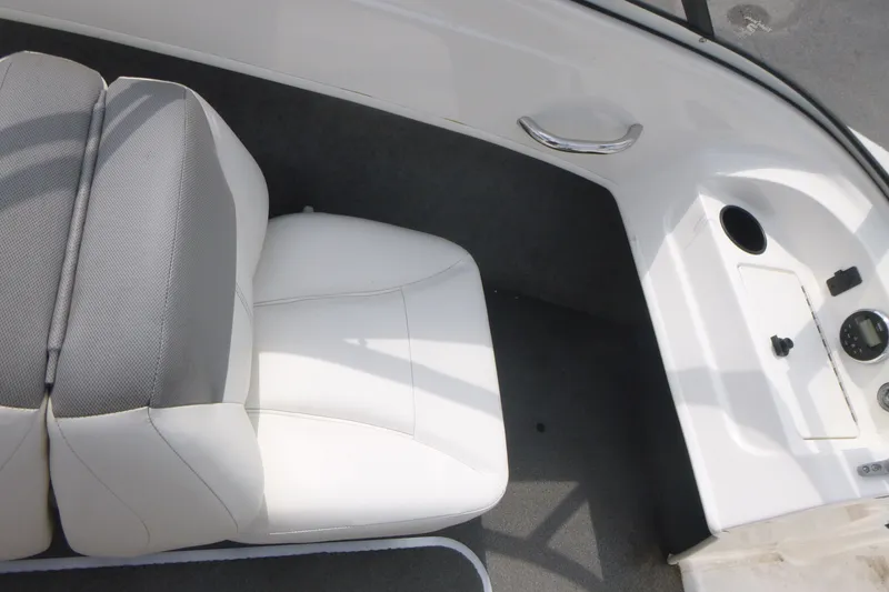 Slide: The Image of 2016 Bayliner 175 Bowrider interior with white seating and dashboard details. - 10