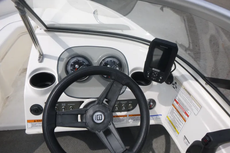 Slide: The Image of 2016 Bayliner 175 Bowrider dashboard with steering wheel and navigation instruments. - 9