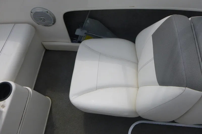 Slide: The Image of Interior seating of a 2016 Bayliner 175 Bowrider boat, featuring white and gray upholstery. - 11