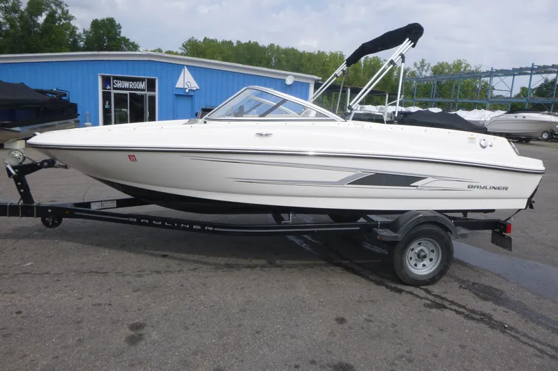 Slide: The Image of 2016 Bayliner 175 Bowrider on trailer outside a blue showroom building. - 4