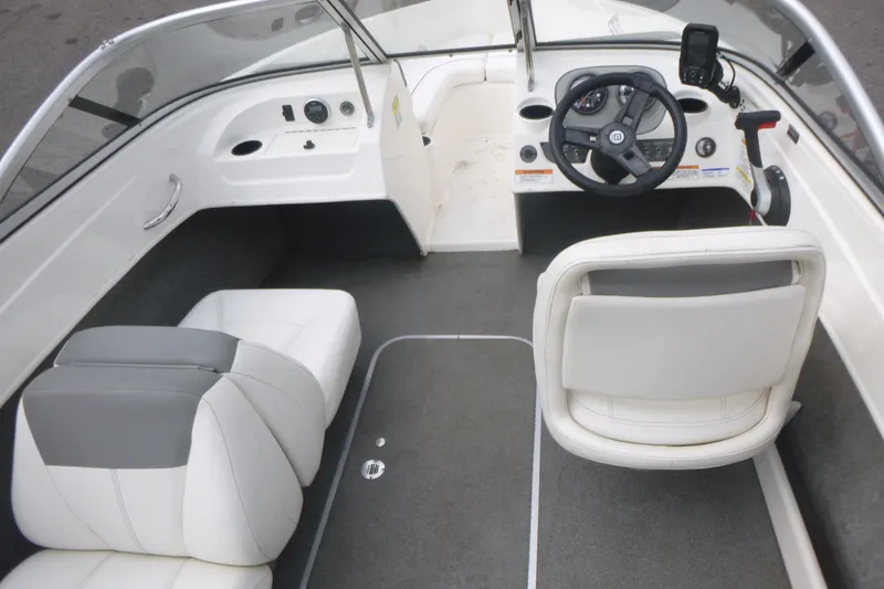 Slide: The Image of 2016 Bayliner 175 Bowrider interior with steering wheel and seating. - 5