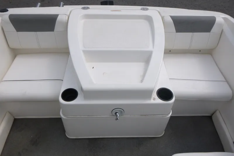 Slide: The Image of 2016 Bayliner 175 Bowrider interior seating with cup holders and storage compartment. - 12