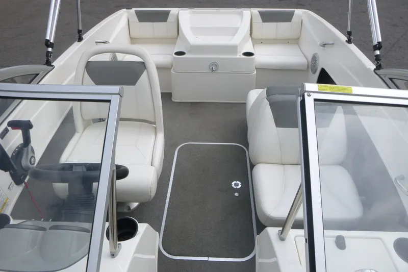 Slide: The Image of 2016 Bayliner 175 Bowrider interior with white seating and steering console. - 6