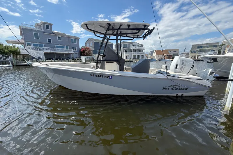 The Image of 2025 Sea Chaser 22 HFC boat docked in a residential waterfront area. - 0