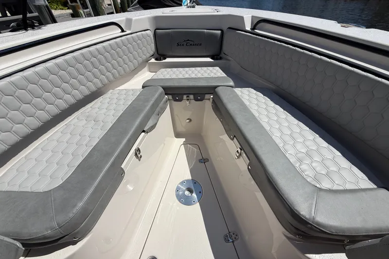 Slide: The Image of 2025 Sea Chaser 22 HFC boat interior with gray cushioned seating and hexagonal pattern. - 1